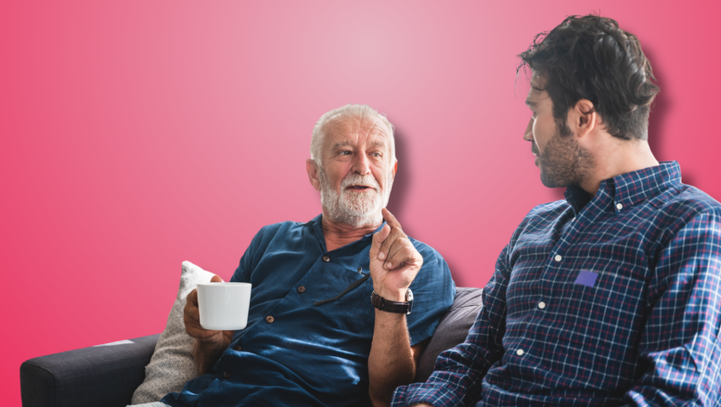 Current image: Older man holding a coffee cup talking to a younger man. Both are wearing blue button up shirts.